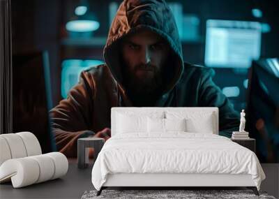 Brute force attack, man in hoodie typing on keyboard serious expression Wall mural