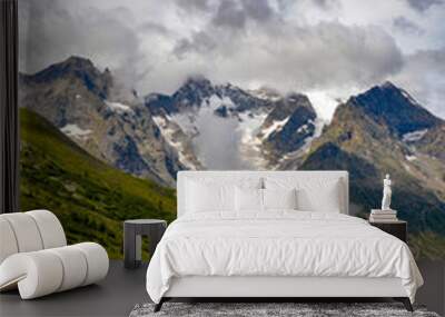 Rocky cliff with snow, and green grass in Jura mountain, France. Wall mural