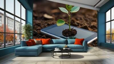 Green future multimedia content creation symbolized by growing seedling on a lying mobile phone, green investment concept,rising money to invest, financial growth concept Wall mural