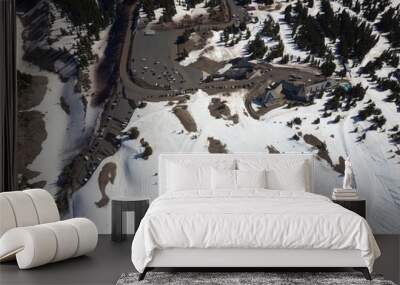 A snowy mountain with a ski resort in the background Wall mural