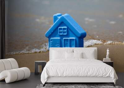 Toy plastic house on the sand washes wave Wall mural