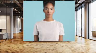 Beautiful African American girl confidently looking in camera over colorful background Wall mural