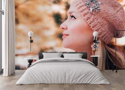 Beautiful blond woman with flowers looking up. Profile spring portrait. Wall mural