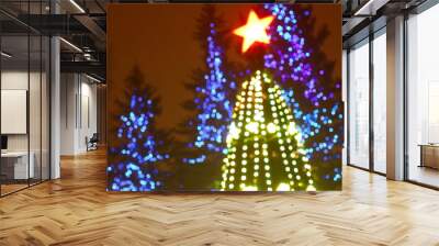 Abstract christmas tree background with defocused lights.  Wall mural