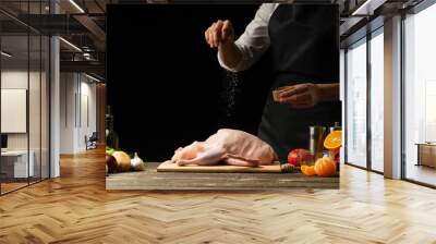 Cooking Peking Duck chef with fruit, on a black background. Horizontal photo, space for menu and design, restaurants, hotel business. Wall mural