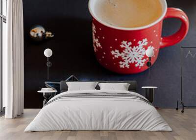 Cup of coffee with christmas decorations on dark background Wall mural