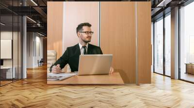 Businessman at a workspace typing Wall mural