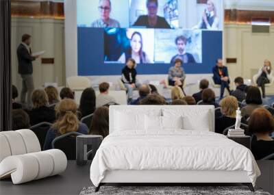 Audience listening to online speakers on screen Wall mural