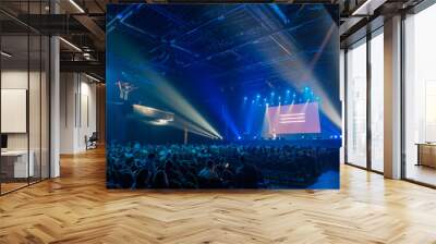 Audience sitting in front of stage with screen Wall mural