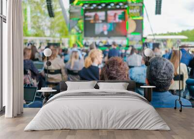 Participants of open air conference listening to speaker Wall mural