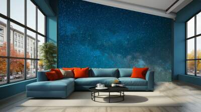 On the starry night sky, the Milky Way. The bright blue colors of the sky and the quiet twinkling of the stars create a fabulous picture. High angle view. Background. Wallpaper. Wall mural