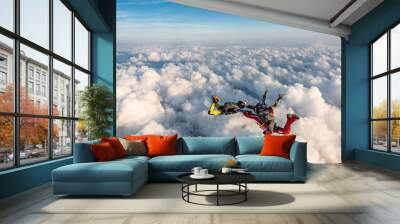 Group of skydivers above the clouds. Wall mural