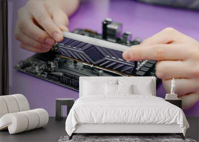 system administrator installing random access memory into motherboard, assembling PC of different accessories or components, close-up view of hands, computer repair and maintenance concept Wall mural