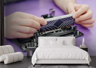 system administrator installing random access memory into motherboard, assembling PC of different accessories or components, close-up view of hands, computer repair and maintenance concept Wall mural