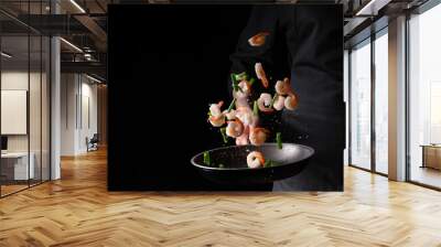 Seafood, chef prepares shrimps with green beans in a frying pan, roasts. On a black background for design, menus, restaurants, oriental cuisine, healthy food Wall mural