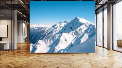 snow-covered mountains and forest against the blue sky Wall mural