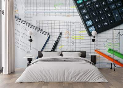 Tables with accounting calculations, paper notebook with records, calculator, pen and highlighter Wall mural