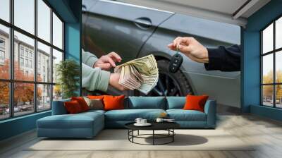 Deal of buy or rental car concept. Exchange money and car keys Wall mural