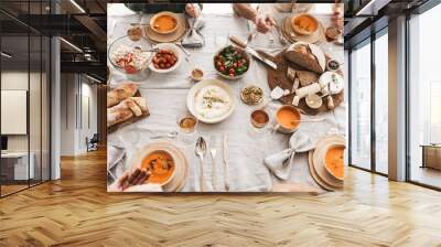 Top view of table full of delicious food. Close up fresh bread with cheese and bowls with pumpkin soups on lunch in cafe Wall mural