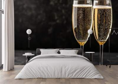 Two champagne glasses on dark backdrop, celebration theme Wall mural