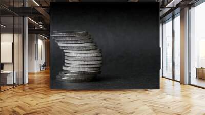 curved pile of coins on a black background Wall mural