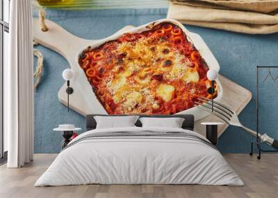 Baked anelletti pasta with mince, sauce and mozzarella. Typical sicilian dish Wall mural