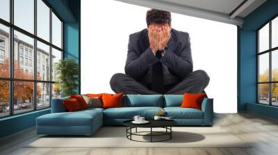 Depressed young businessman sitting on the ground Wall mural