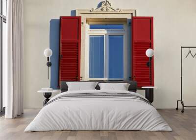 Italian window on the bright white wall facade with open red color classic shutters Wall mural