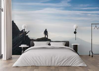 Man silhouette on top of mountain peak Wall mural