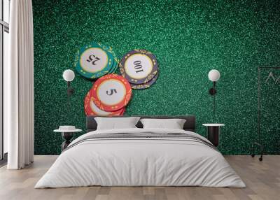 Three stacks of poker chips with 5, 25 and 100 values on the bright brilliant green background Wall mural