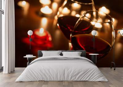 two wineglasses and candles in darkness Wall mural