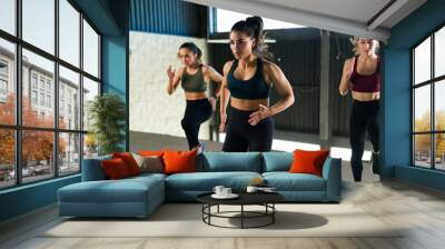 Athletic woman in activewear working out indoors Wall mural