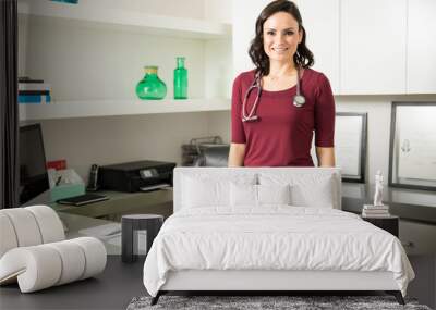 Beautiful female doctor in her office Wall mural