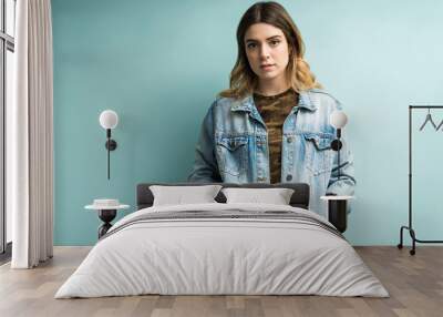 Beautiful Female Wearing Denim Jacket In Studio Wall mural