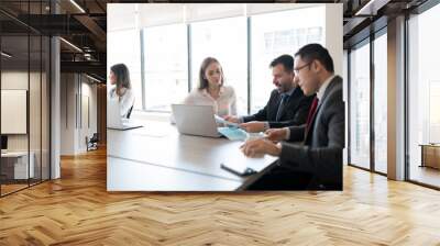 Business team reviewing paperwork in a meeting Wall mural