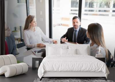 Businessman putting forward some suggestions in meeting Wall mural