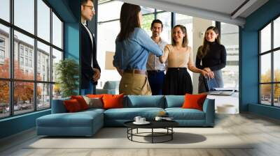 Businesswomen shaking hands and closing a business deal Wall mural