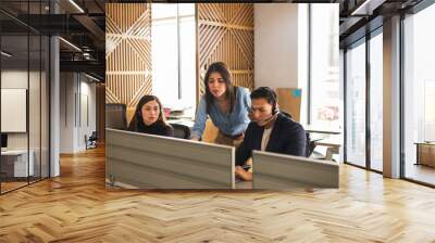 Call center supervisor checking on some sales representatives in the office Wall mural