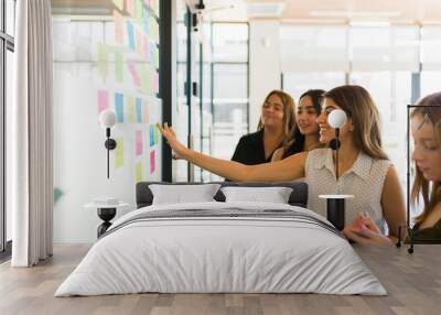 Cheerful women smiling while brainstorming Wall mural