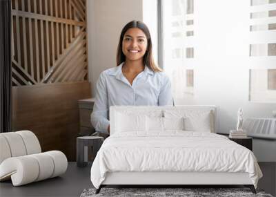 Confident young businesswoman at work Wall mural