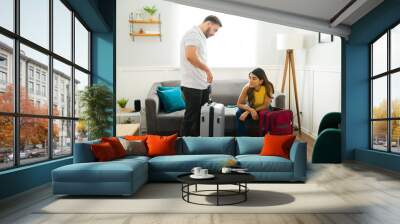 Couple preparing their suitcases for vacations Wall mural