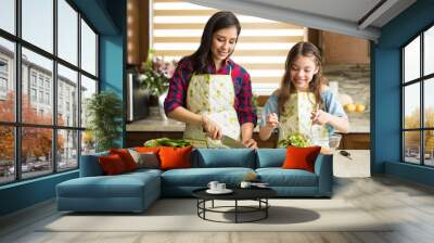 Cute family making a salad at home Wall mural