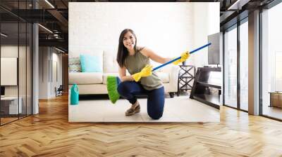 Cute woman playing guitar with broom Wall mural