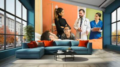 Doctors Explaining Family At Hospital Wall mural