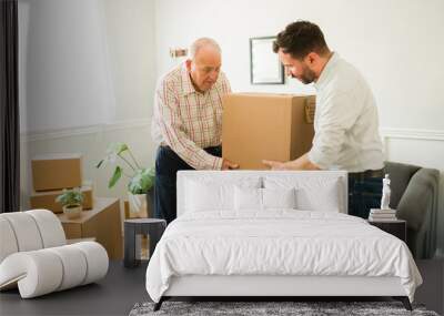 Elderly man moving into a new apartment with the help of his son Wall mural