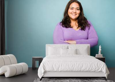 Fat latin young woman looking happy Wall mural