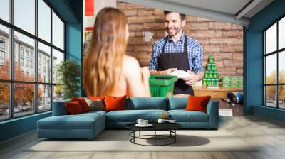 Handsome cashier enjoying his work Wall mural