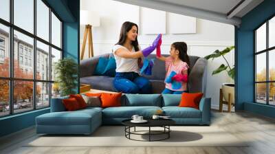 Happy mother and daughter giving a high five after the house chores Wall mural