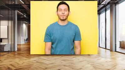 Hispanic young man thinking about delicious food Wall mural