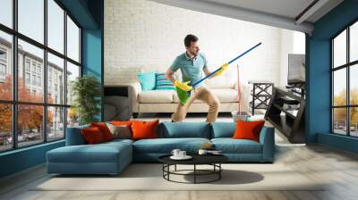 man having fun doing house chores Wall mural